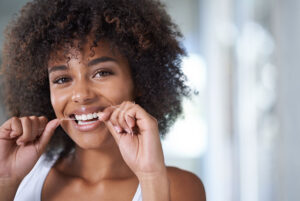 Woman flossing her teeth